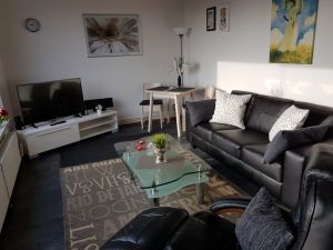 Gemütliches Wohnzimmer mit Blick durch das Panoramafenster direkt auf das Meer. Im Sitzen!
