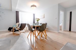 Im Vordergrund der Esstisch, im Hintergrund Couch und Sessel